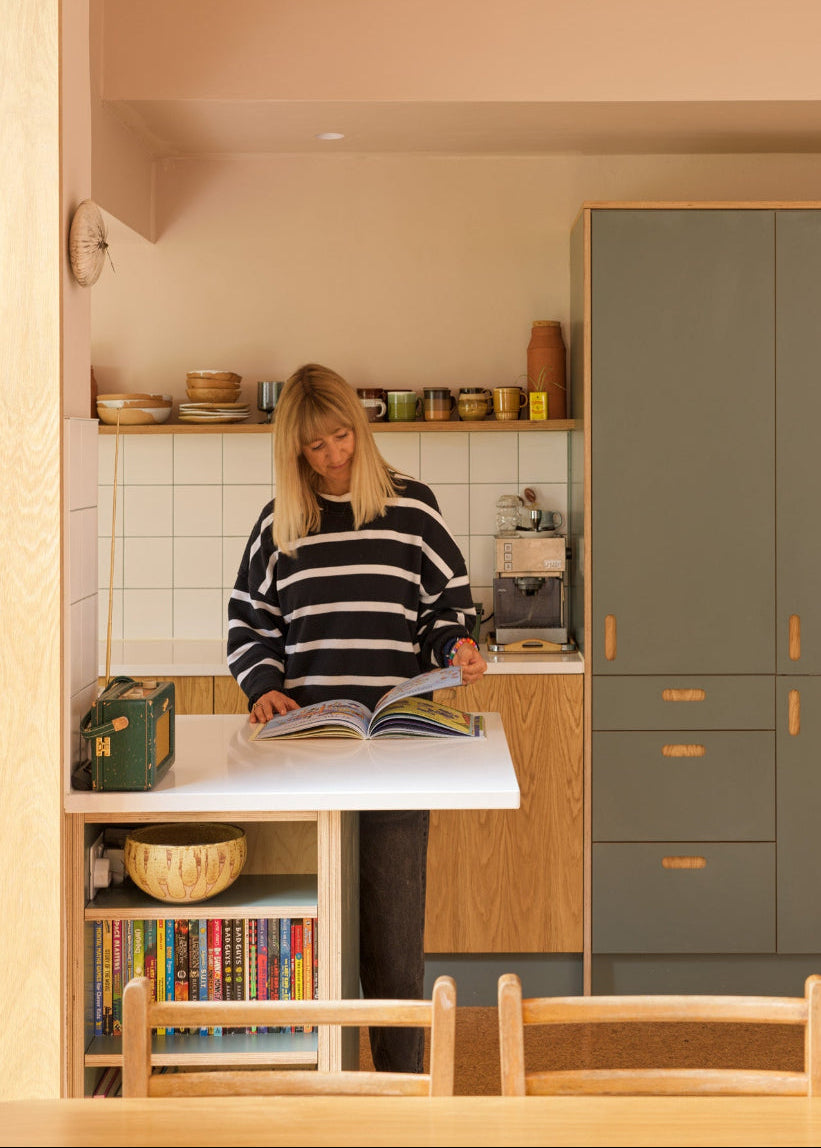 A Wren kitchen transformed with Green Slate Formica and oak plywood fronts, bespoke shelving, island bookshelves and a custom sliding door.