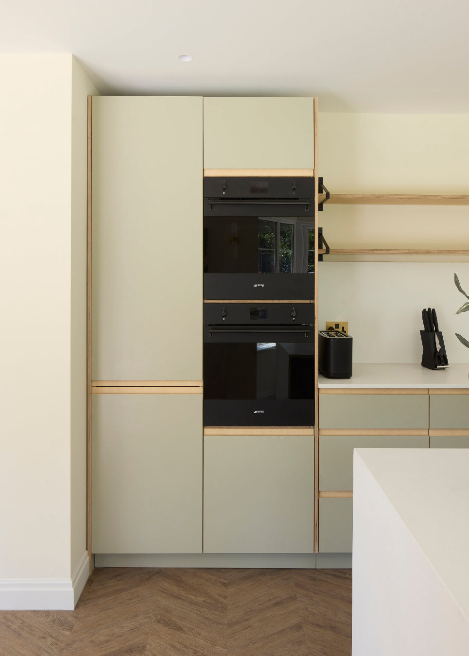 A fully custom Made in Ply kitchen. Birch plywood, Formica Seed green and bespoke plywood shelving create a warm, contemporary space with beautifully considered architectural detailing.